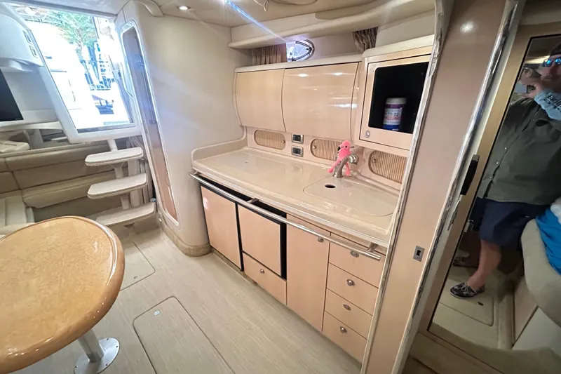 Slide: The Image of Interior of 2004 Sea Ray 360 Sundancer with beige seating and carpeted steps. - 21
