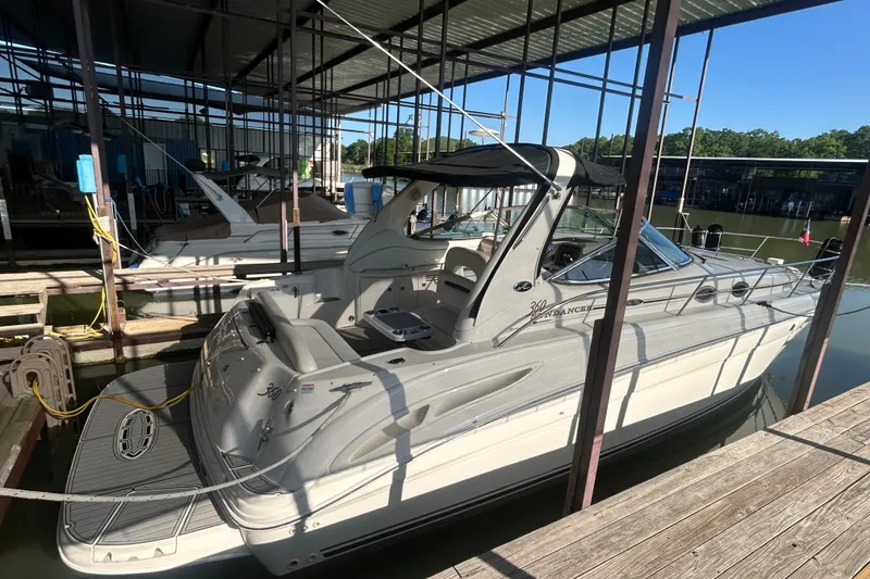 Slide: The Image of 2004 Sea Ray 360 Sundancer boat with black canopy and sleek interior design. - 3