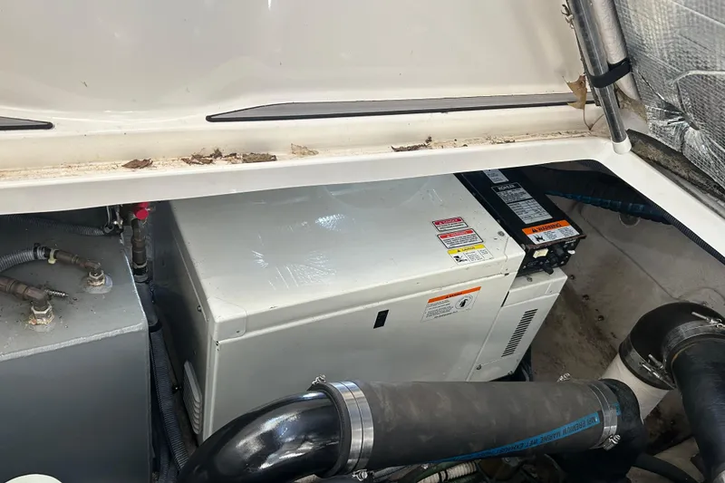 Slide: The Image of Engine compartment of a 2004 Sea Ray 360 Sundancer, showing generator and piping. - 31