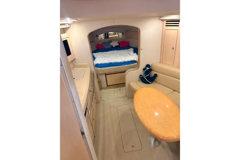 Slide: The Image of Interior of 2004 Sea Ray 360 Sundancer yacht with cozy cabin and seating area. - 36