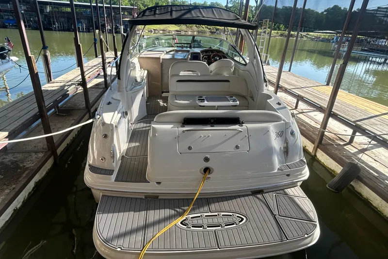 Slide: The Image of 2004 Sea Ray 360 Sundancer docked in a covered marina, sunny day. - 6