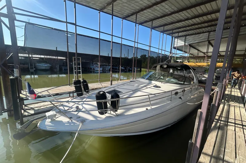 Slide: The Image of 2004 Sea Ray 360 Sundancer docked, showcasing spacious swim platform and sleek design. - 8