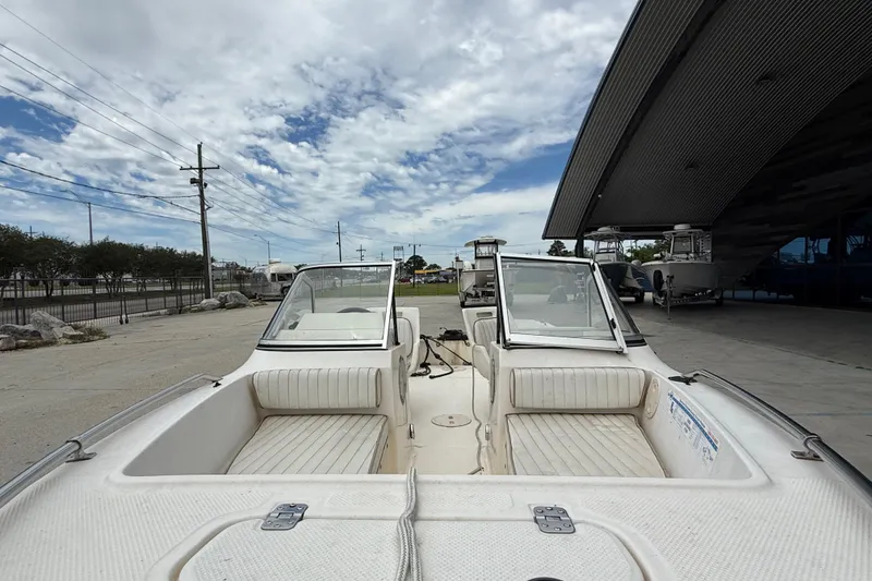 Slide: The Image of 2001 Key West 1720 Dual Console boat parked outdoors under a cloudy sky. - 10