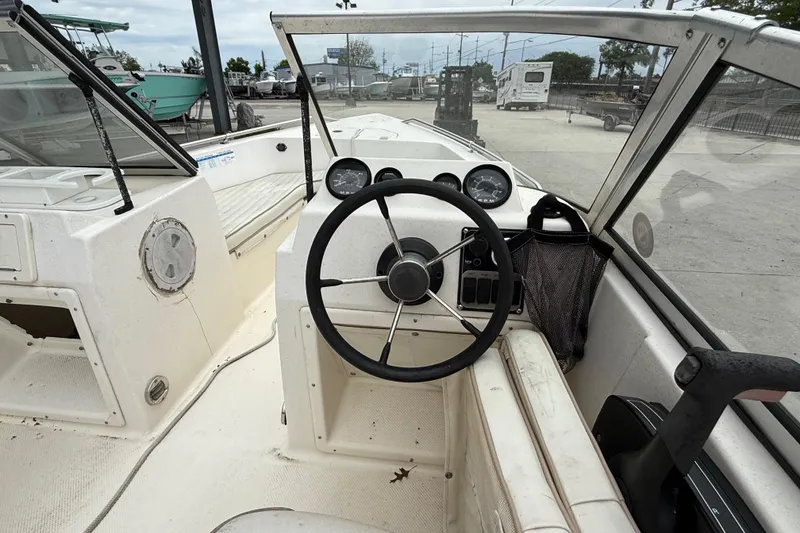 Slide: The Image of 2001 Key West 1720 Dual Console boat interior with steering wheel and dashboard controls. - 11