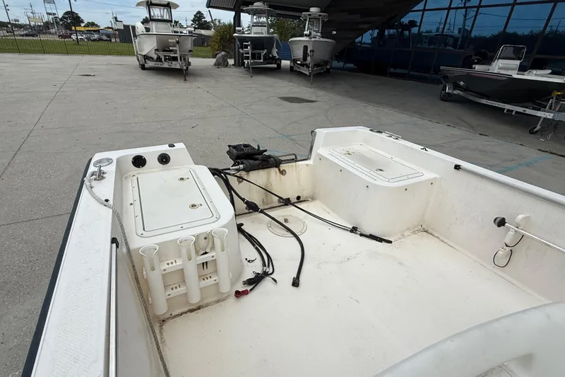 Slide: The Image of 2001 Key West 1720 Dual Console boat interior, showing storage compartments and fishing rod holders. - 12