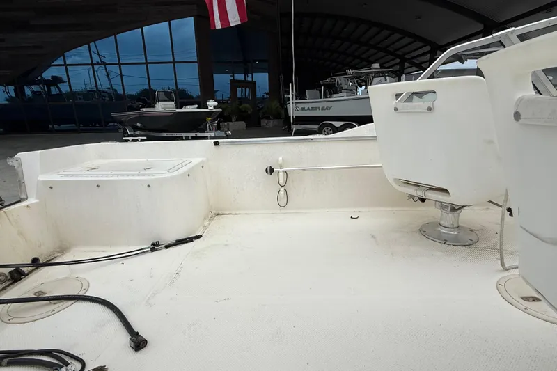 Slide: The Image of 2001 Key West 1720 Dual Console boat interior with seating and storage compartments. - 13