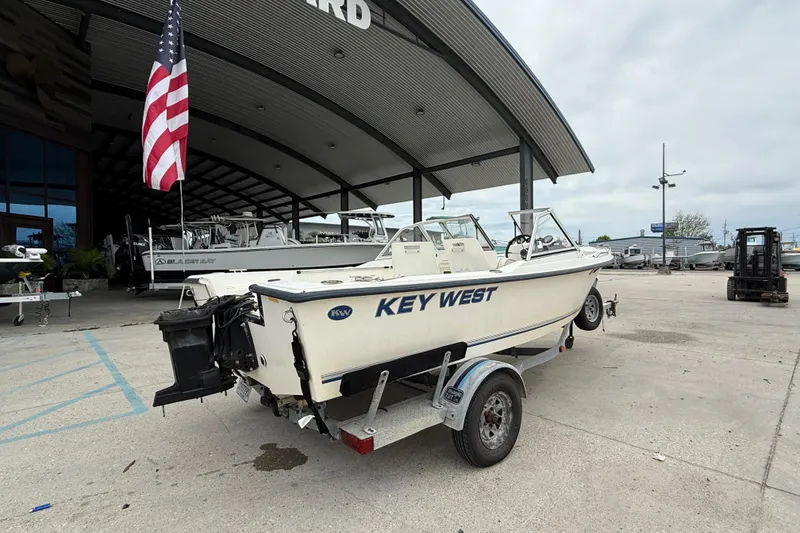 Slide: The Image of 2001 Key West 1720 Dual Console boat on trailer, parked outside dealership. - 3