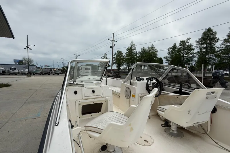 Slide: The Image of 2001 Key West 1720 Dual Console boat interior with steering wheel and seating. - 8