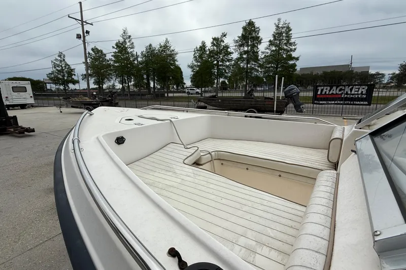 Slide: The Image of 2001 Key West 1720 Dual Console boat with spacious seating, parked outdoors. - 9