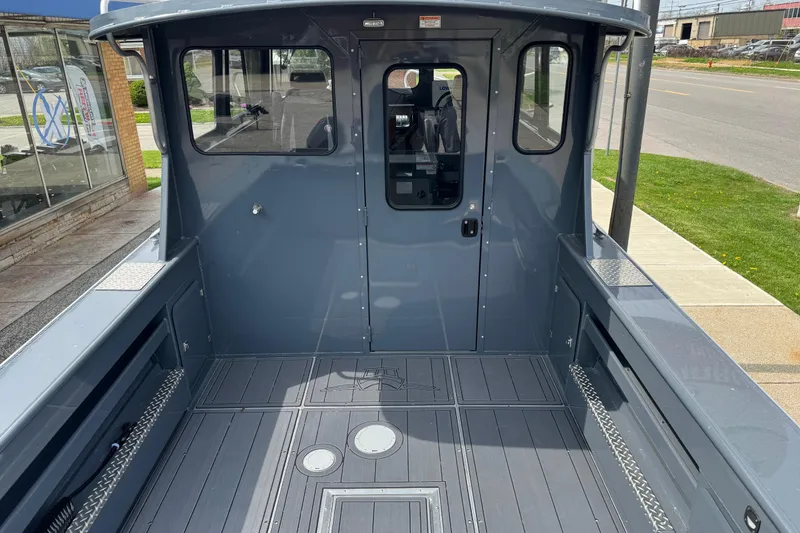 Slide: The Image of 2025 Hewescraft 240 Pacific Cruiser boat interior, featuring spacious deck and modern design. - 10