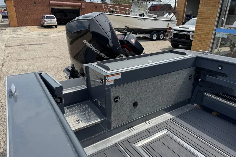 Slide: The Image of 2025 Hewescraft 240 Pacific Cruiser with Mercury outboard motor in a dealership lot. - 11