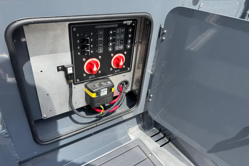 Slide: The Image of Electrical panel of 2025 Hewescraft 240 Pacific Cruiser with battery switches and wiring. - 13