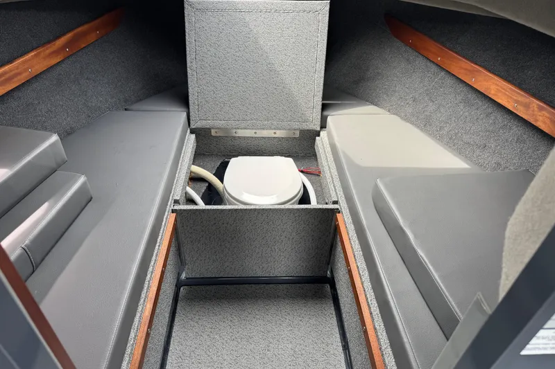 Slide: The Image of Interior of 2025 Hewescraft 240 Pacific Cruiser with compact marine toilet. - 28