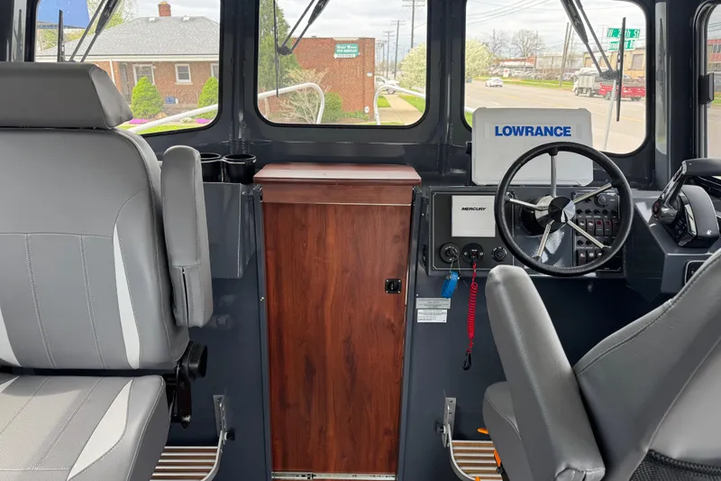 Slide: The Image of Interior of 2025 Hewescraft 240 Pacific Cruiser with steering wheel and navigation equipment. - 30