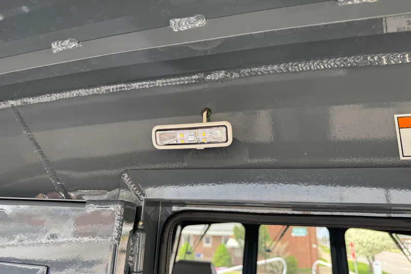 Slide: The Image of Interior light fixture inside a 2025 Hewescraft 240 Pacific Cruiser boat. - 31