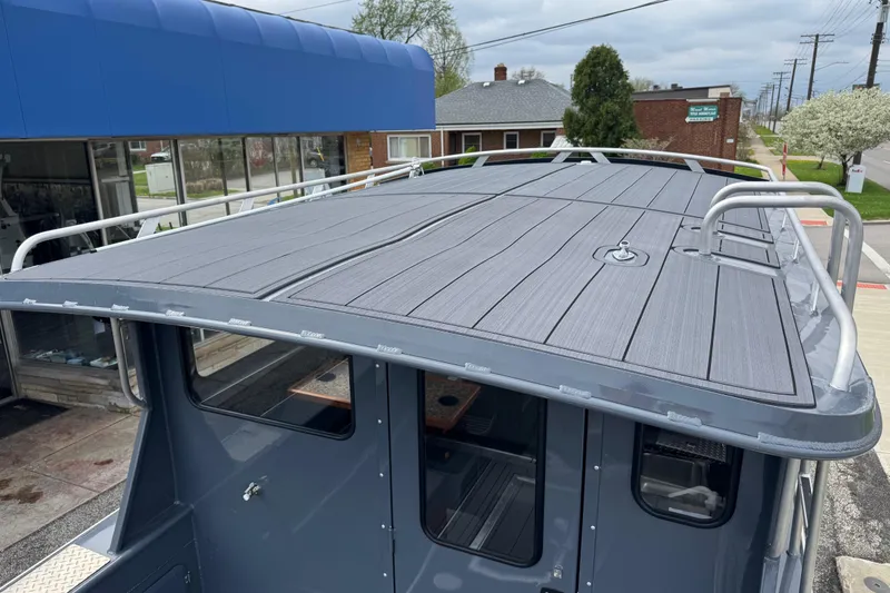 Slide: The Image of 2025 Hewescraft 240 Pacific Cruiser boat roof with sleek design and sturdy railings. - 33