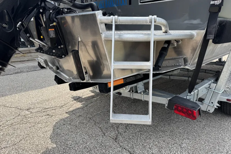 Slide: The Image of Rear view of 2025 Hewescraft 240 Pacific Cruiser with ladder and trailer. - 6