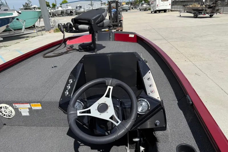 Slide: The Image of 2023 Crestliner 1850 SC boat dashboard with steering wheel and control panel. - 11