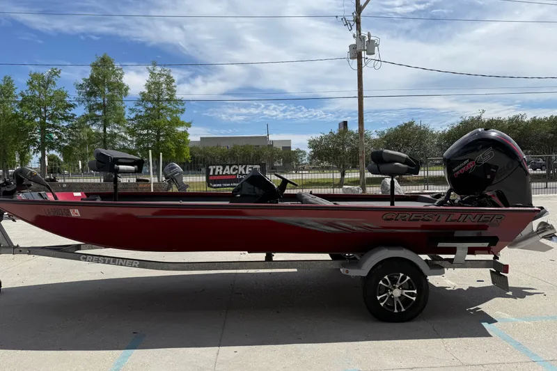 Slide: The Image of 2023 Crestliner 1850 SC boat on trailer, red exterior, parked outdoors. - 7