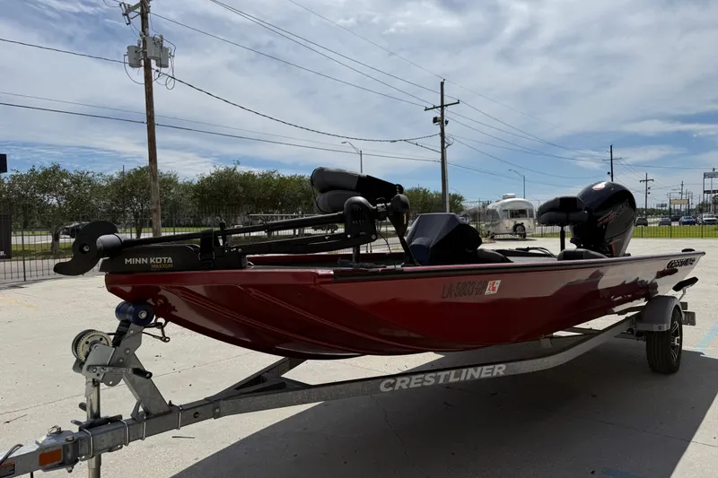 Slide: The Image of 2023 Crestliner 1850 SC boat on trailer with Minn Kota motor, parked outdoors. - 8