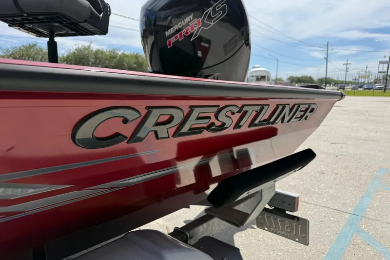 Slide: The Image of 2023 Crestliner 1850 SC boat with Mercury Pro XS engine, parked outdoors. - 9