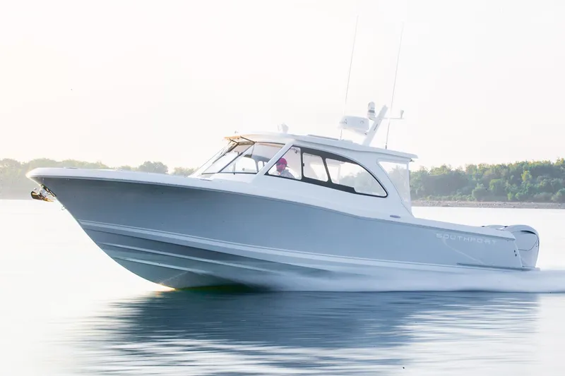 Slide: The Image of Manufacturer Provided Image: 2025 Southport 33 DC boat cruising on calm water. - 1