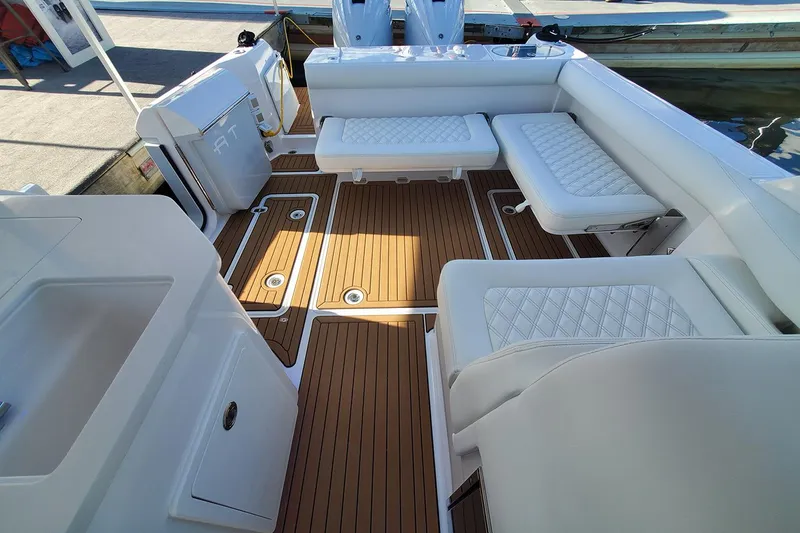 Slide: The Image of Manufacturer Provided Image: 2025 Southport 33 DC boat interior with cushioned seating and teak flooring. - 10