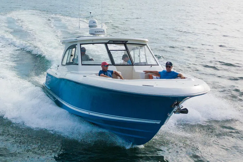 Slide: The Image of Manufacturer Provided Image: 2025 Southport 33 DC boat cruising on open water with passengers onboard. - 2