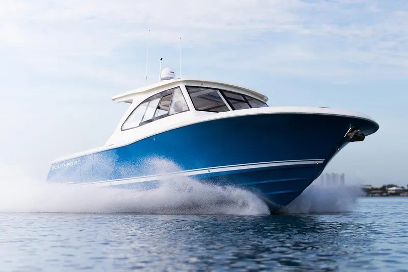 Slide: The Image of Manufacturer Provided Image: 2025 Southport 33 DC boat cruising on water, showcasing sleek design and performance. - 5