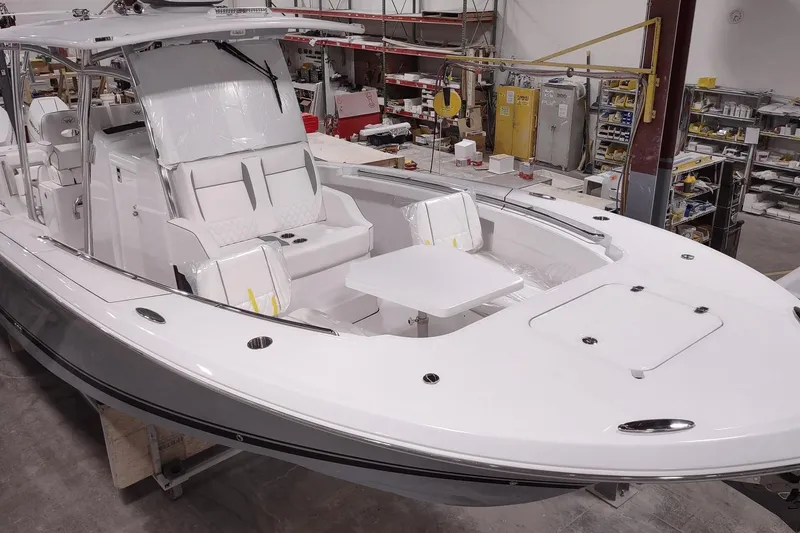 Slide: The Image of 2026 Southport 33 FE boat under construction in a workshop. - 10