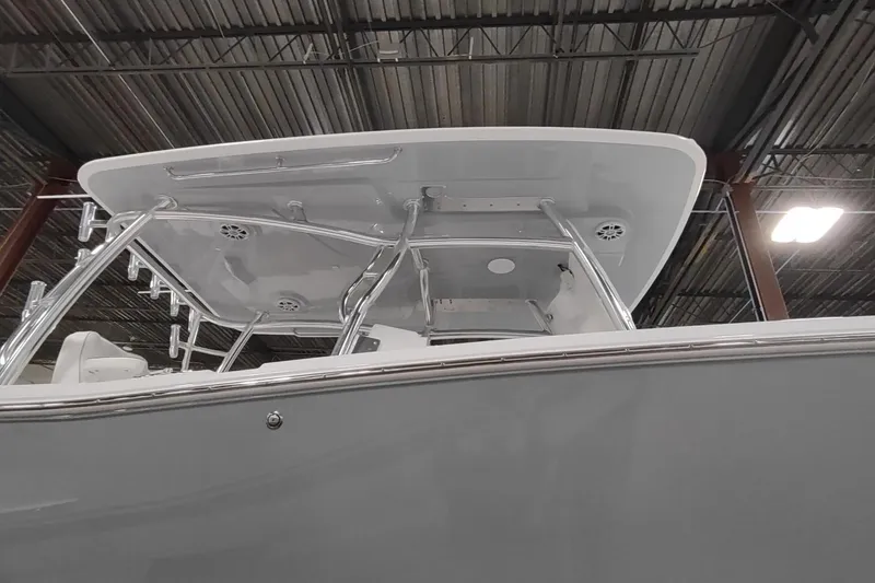 Slide: The Image of 2026 Southport 33 FE boat indoors, featuring T-top design. - 2