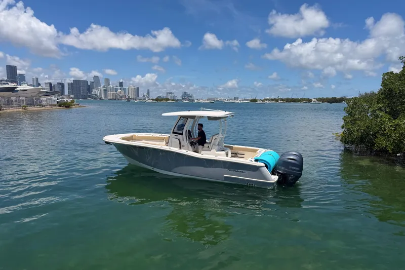 Slide: The Image of 2019 Pioneer 266 Pelagic boat on water with city skyline in background. - 11