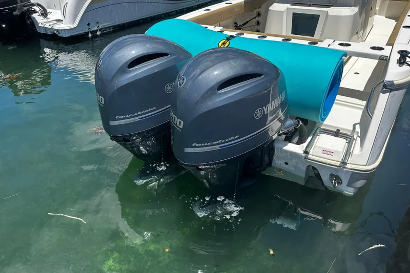 Slide: The Image of Twin Yamaha outboard motors on a 2019 Pioneer 266 Pelagic boat in water. - 12