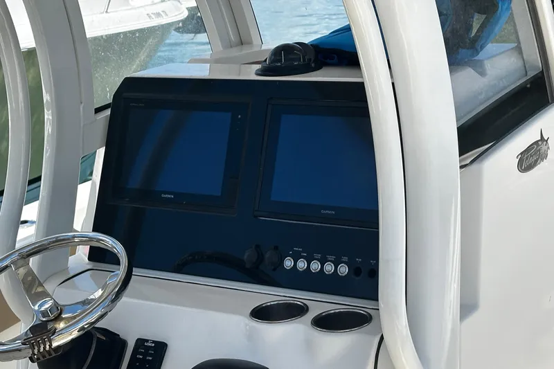 Slide: The Image of 2019 Pioneer 266 Pelagic boat dashboard with dual Garmin displays and steering wheel. - 14