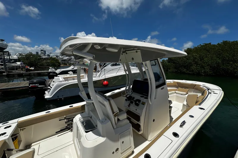 Slide: The Image of 2019 Pioneer 266 Pelagic boat docked, featuring a sleek console and spacious seating. - 15