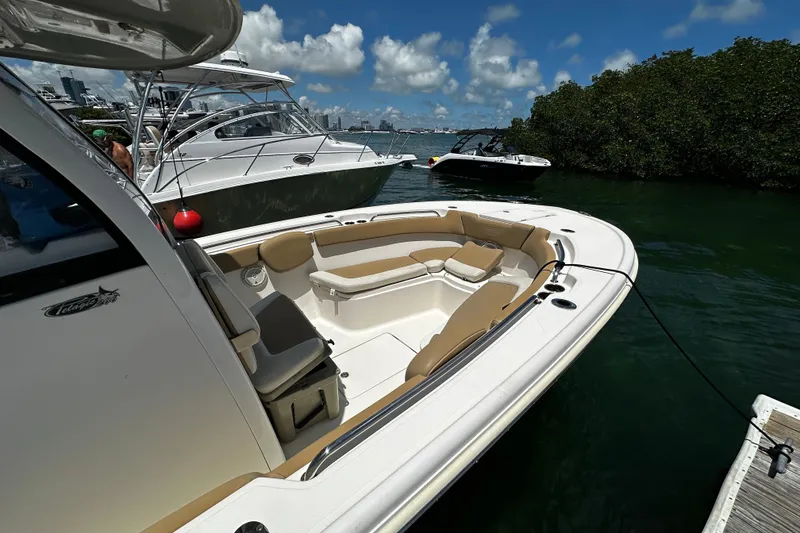Slide: The Image of 2019 Pioneer 266 Pelagic boat docked, featuring spacious seating and sleek design. - 16
