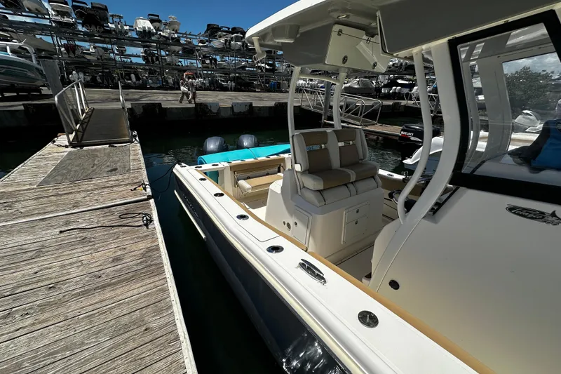 Slide: The Image of 2019 Pioneer 266 Pelagic boat docked at marina with dual engines. - 17