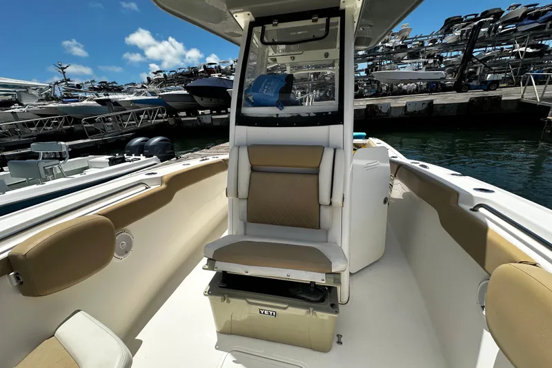 Slide: The Image of 2019 Pioneer 266 Pelagic boat interior with seating and storage, docked at marina. - 28