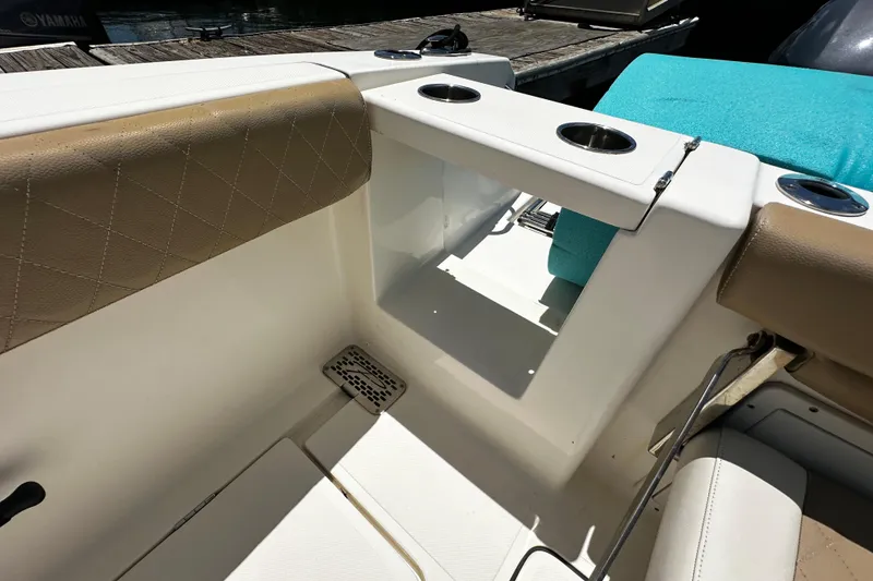 Slide: The Image of 2019 Pioneer 266 Pelagic boat interior with cup holders and cushioned seating. - 33