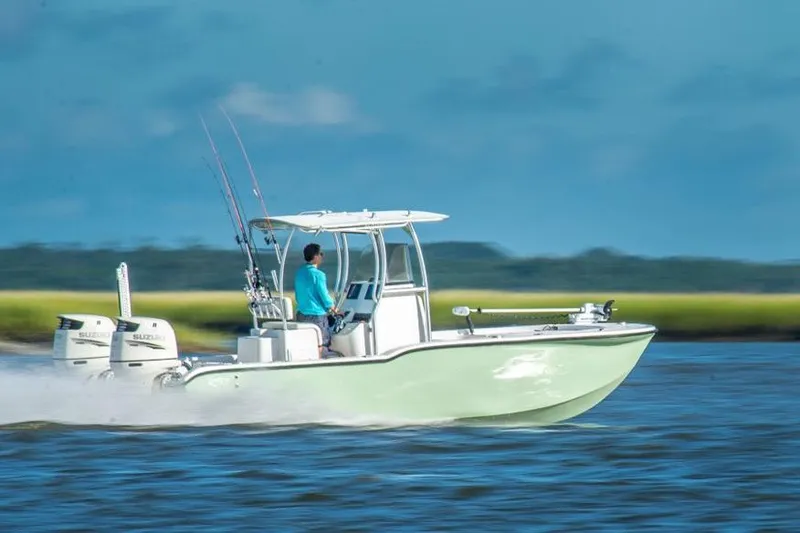 The Image of 2026 Tideline 235 Hybrid boat speeding on water with dual engines. - 0