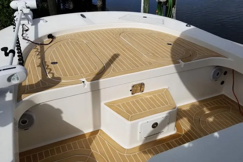 Slide: The Image of 2026 Tideline 235 Hybrid boat deck with tan non-slip surface, featuring storage compartments. - 12