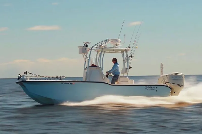 Slide: The Image of 2026 Tideline 235 Hybrid boat cruising on open water under clear skies. - 3