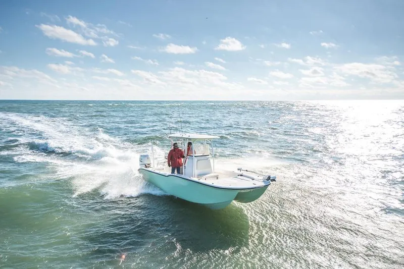 Slide: The Image of 2026 Tideline 235 Hybrid boat cruising on open sea under clear blue sky. - 6