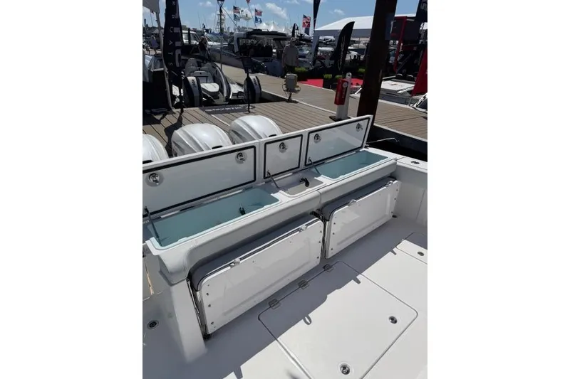 Slide: The Image of 2026 Southport 38 FE boat with open storage compartments at the dock. - 4
