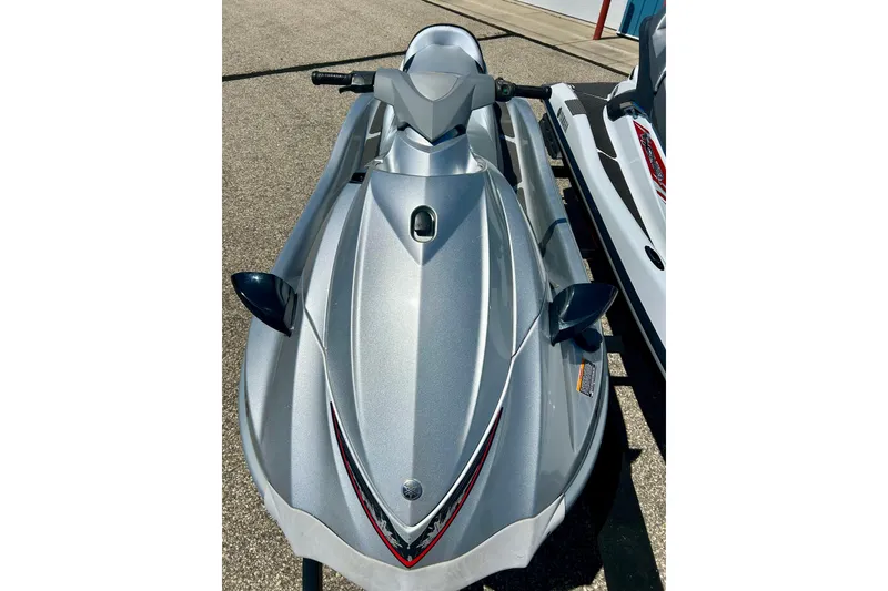 Slide: The Image of 2016 Yamaha FX Cruiser SHO jet ski in silver, parked on pavement. - 12