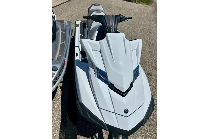 Slide: The Image of 2016 Yamaha FX Cruiser SHO jet ski, sleek white design, parked on pavement. - 22