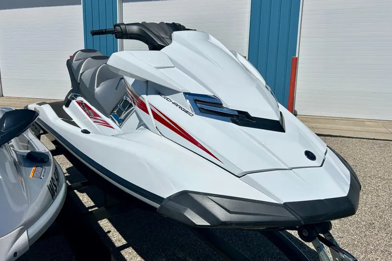 Slide: The Image of 2016 Yamaha FX Cruiser SHO jet ski, white with red accents, parked outdoors. - 5