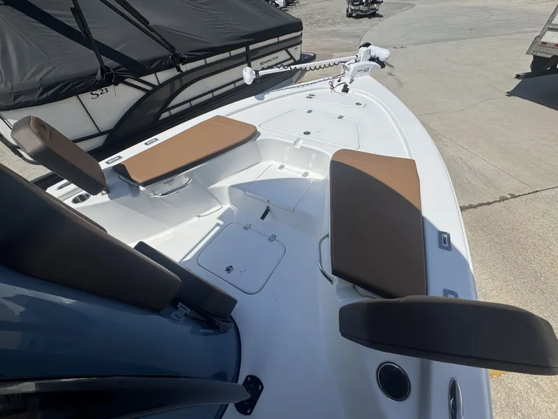 Slide: The Image of 2026 Sea Pro 230 DLX boat with brown seats and white deck. - 13