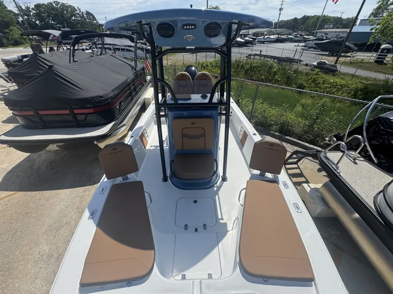 Slide: The Image of 2026 Sea Pro 230 DLX boat with brown seating outdoors. - 14