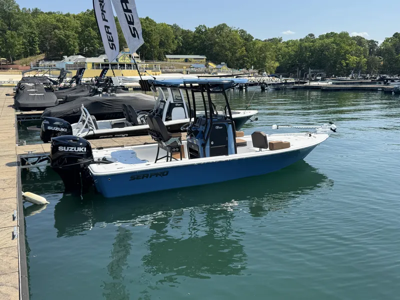 Slide: The Image of 2026 Sea Pro 230 DLX boat docked with Suzuki engine. - 3